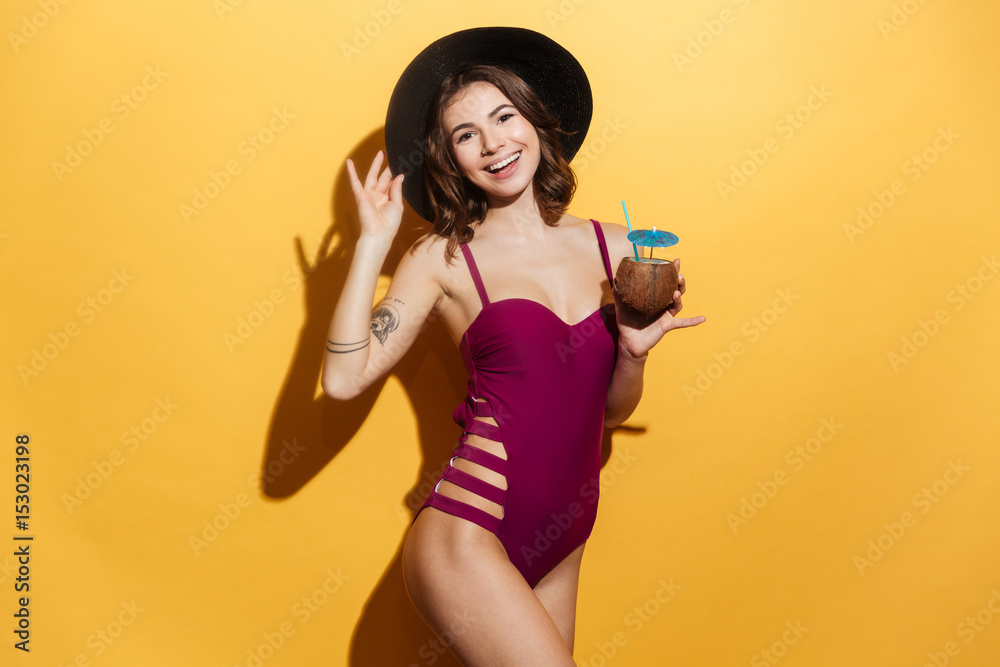 Portrait of a happy woman in beach hat and swimsuit Portrait of a happy woman in beach hat and swimsuit