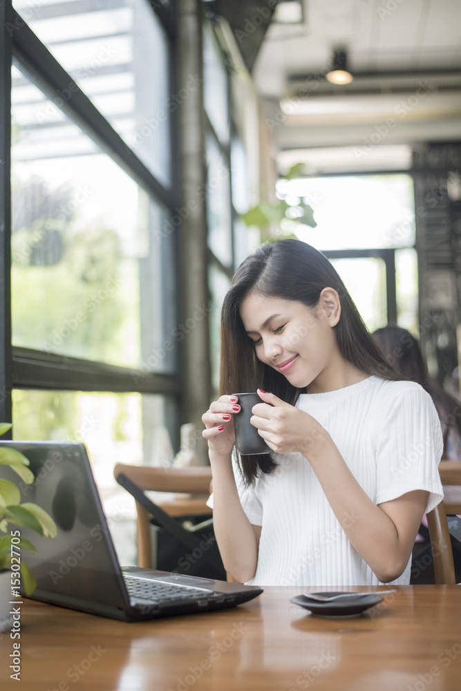 Fototapeta premium Beautiful business girl working with tablet , smartphone and drinking coffee in coffee shop