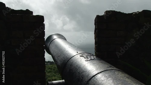 Old cannon looking to the sea in Fort King George in Scarborough,Tobago. Taken during stormy day photo