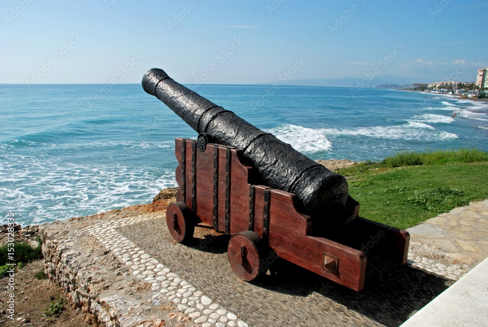 Cannon on the edge of sea with views along the beach and coastline, Torrox Costa, Spain.