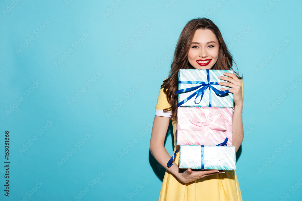 Portrait of a pretty girl holding stack of gift boxes Portrait of a pretty girl holding stack of gift boxes