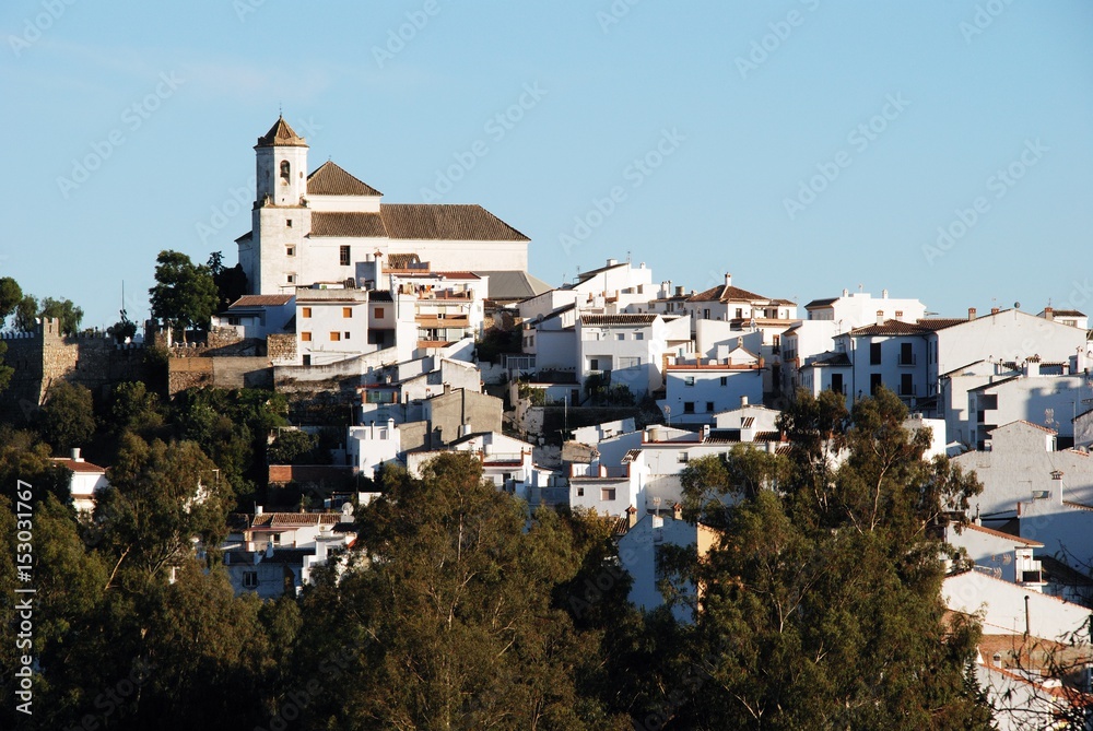 View of the white village with the church at the top, Alozaina, Spain.
