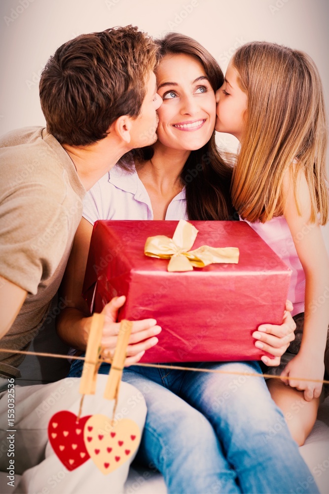 Composite image of father and his daughter offering a gift Composite image of father and his daughter offering a gift