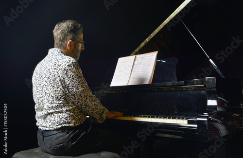 Senior man playing piano photo