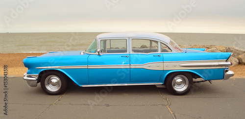  Classic Blue Pontiac Star Chief Motor Car  parked on seafront promenade.