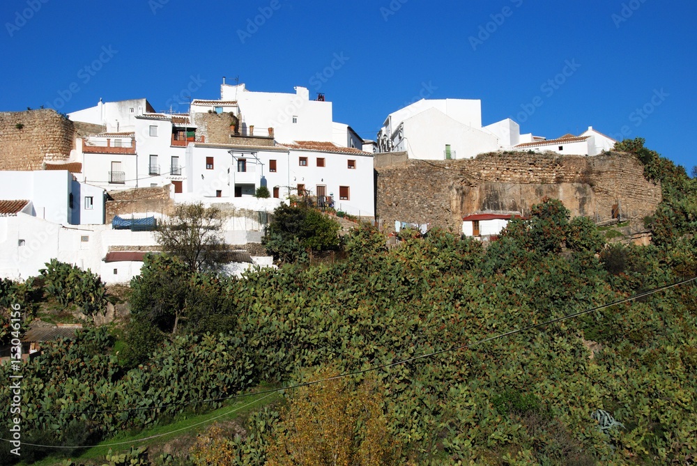 View of the village on the hill showing part of the old village wall, El Burgo, Spain.