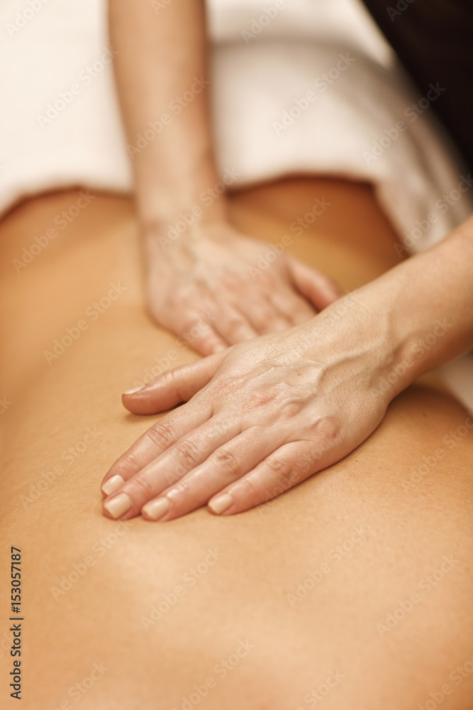 Beautiful woman relaxing receiving body massage at spa center Beautiful woman relaxing receiving body massage at spa center