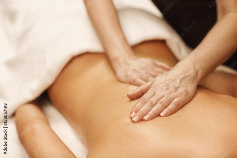 Beautiful woman relaxing receiving body massage at spa center Beautiful woman relaxing receiving body massage at spa center