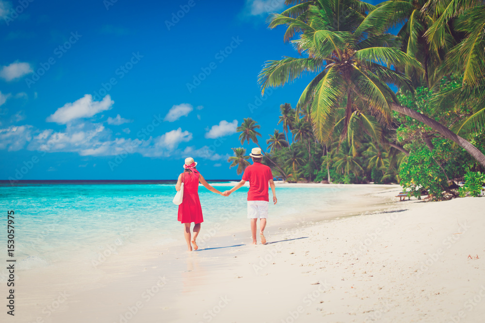 happy loving couple walking on beach