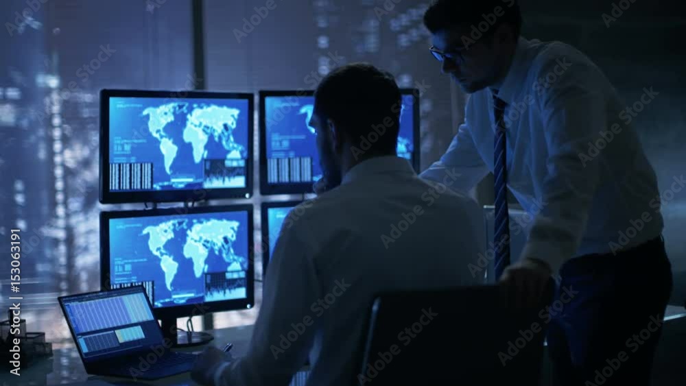 Late at Night in Office Building Security Service Men Have Discussion while Attentively Observing Monitors with Location Sensitive Information Shown on Them. Shot on RED EPIC-W 8K Helium Camera Late at Night in Office Building Security Service Men Have Discussion while Attentively Observing Monitors with Location Sensitive Information Shown on Them. Shot on RED EPIC-W 8K Helium Camera
