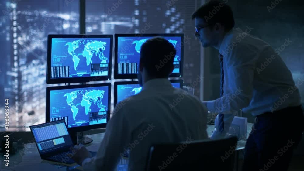 Late at Night in Office Building Security Service Men Have Discussion while Attentively Observing Monitors with Location Sensitive Information Shown on Them. Shot on RED EPIC-W 8K Helium Camera Late at Night in Office Building Security Service Men Have Discussion while Attentively Observing Monitors with Location Sensitive Information Shown on Them. Shot on RED EPIC-W 8K Helium Camera