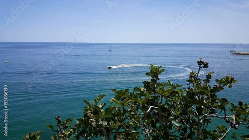 Speedboat with rubber band behind fast on water photo