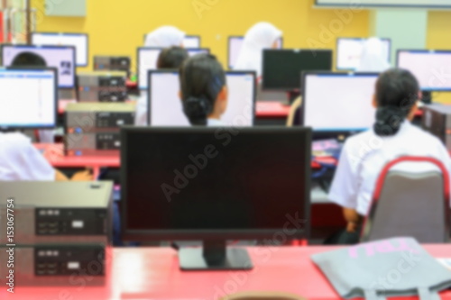 focus blur, the student with teacher learning business technology desktop computer in a classroom © pramot48