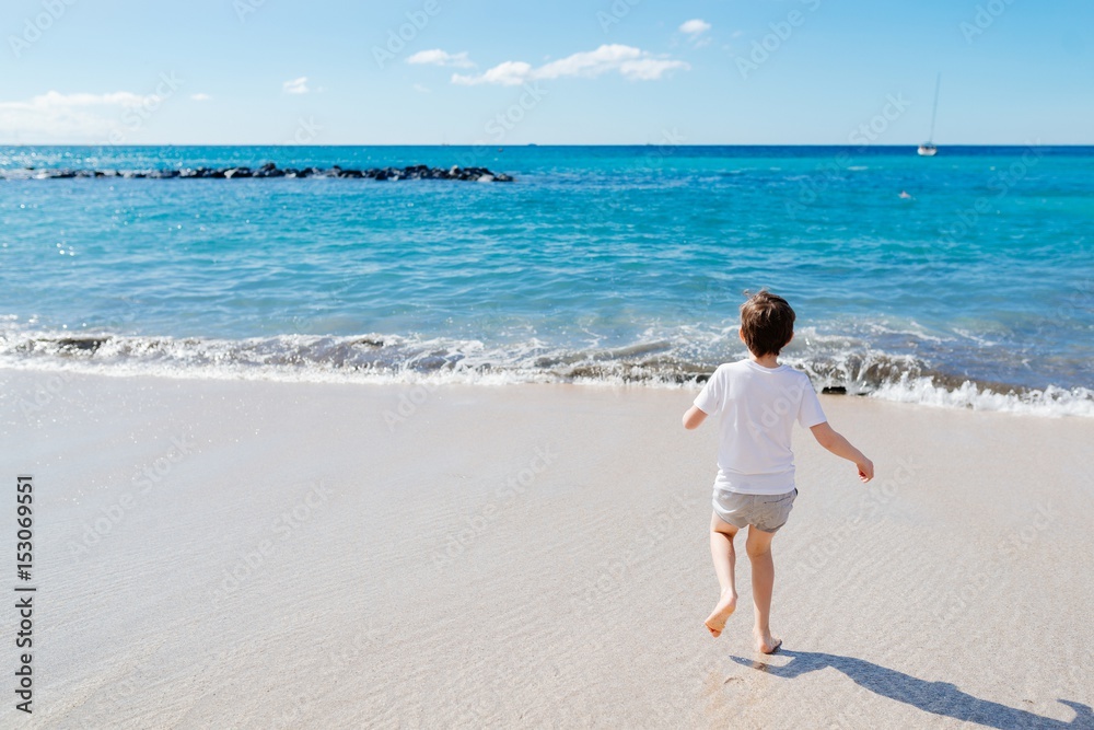 Happy child boy playing on beach Happy child boy playing on beach
