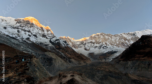 The tops of the Annapurna lighted daybreak segment before sunrise - Nepal, Himalayas photo