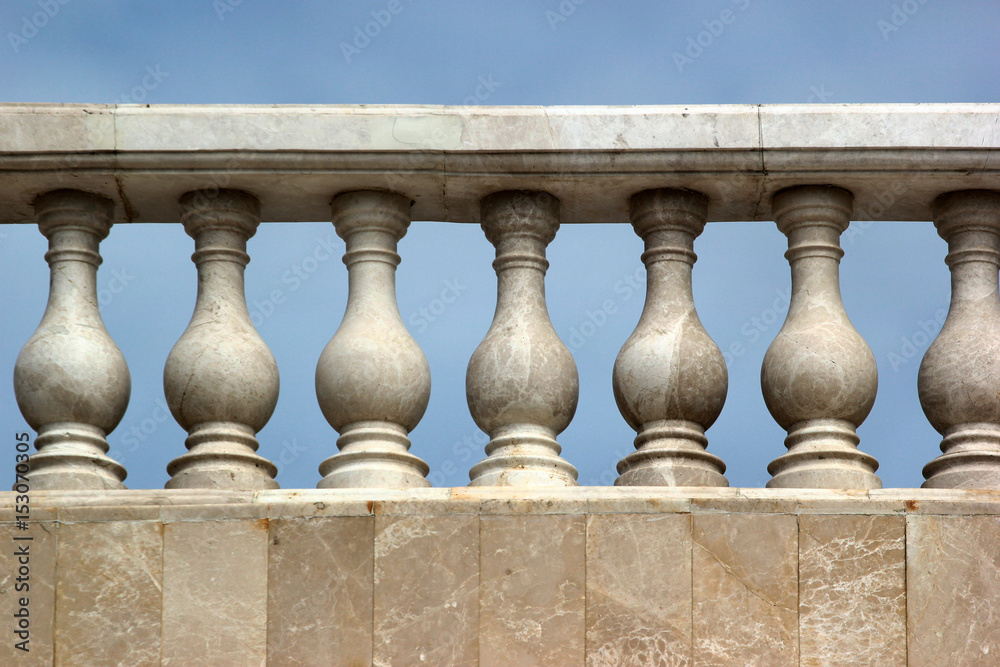 Fototapeta premium Old marble balustrade on blue sky background