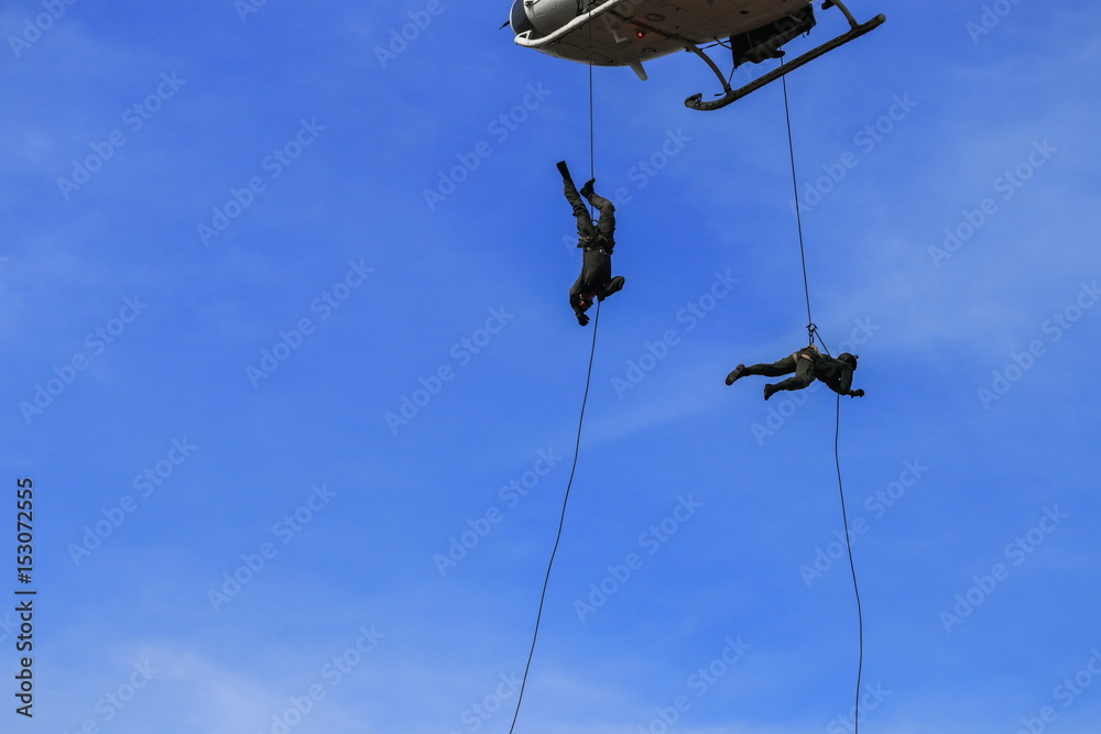 silhouette Soldier Jump rope from helicopter in blue sky