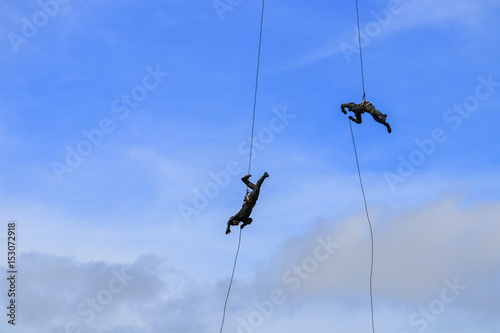 silhouette Soldier Jump rope from helicopter in blue sky