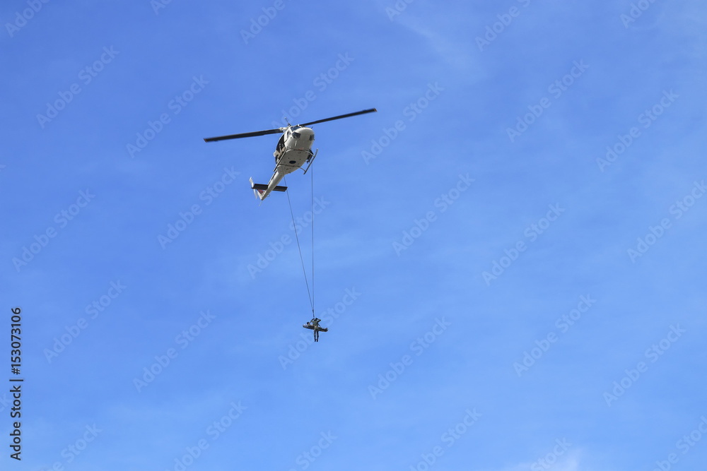Soldier rescue emergency by army helicopter with rope on blue sky and blur propeller Soldier rescue emergency by army helicopter with rope on blue sky and blur propeller