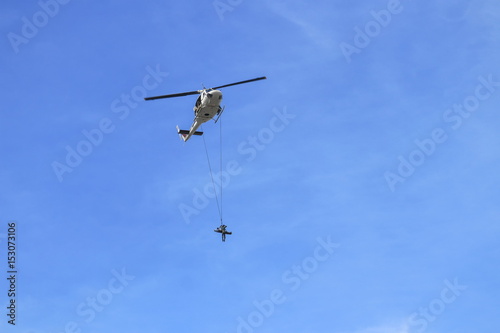 Soldier rescue emergency by army helicopter with rope on blue sky and blur propeller