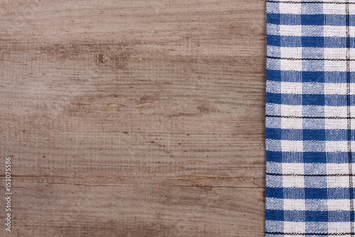 blue checkered tablecloth on an old wooden table with copy space for your text. Top view