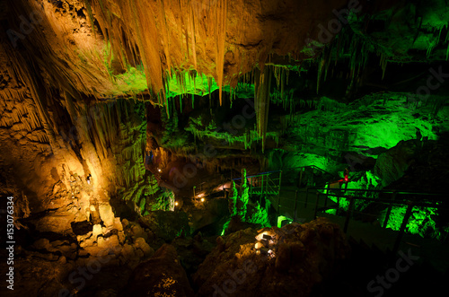 Beautiful illuminated multicolored cave and stalactites from karst Prometheus Cave. Georgia photo