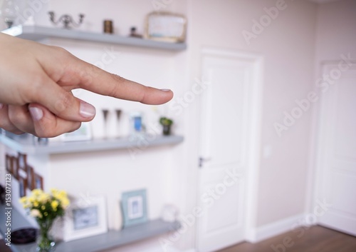 Hand touching air with living room