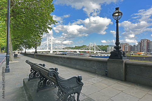 Fototapete Chelsea Embankment on the River Thames and Albert Bridge with summery, blue, cloud flecked sky