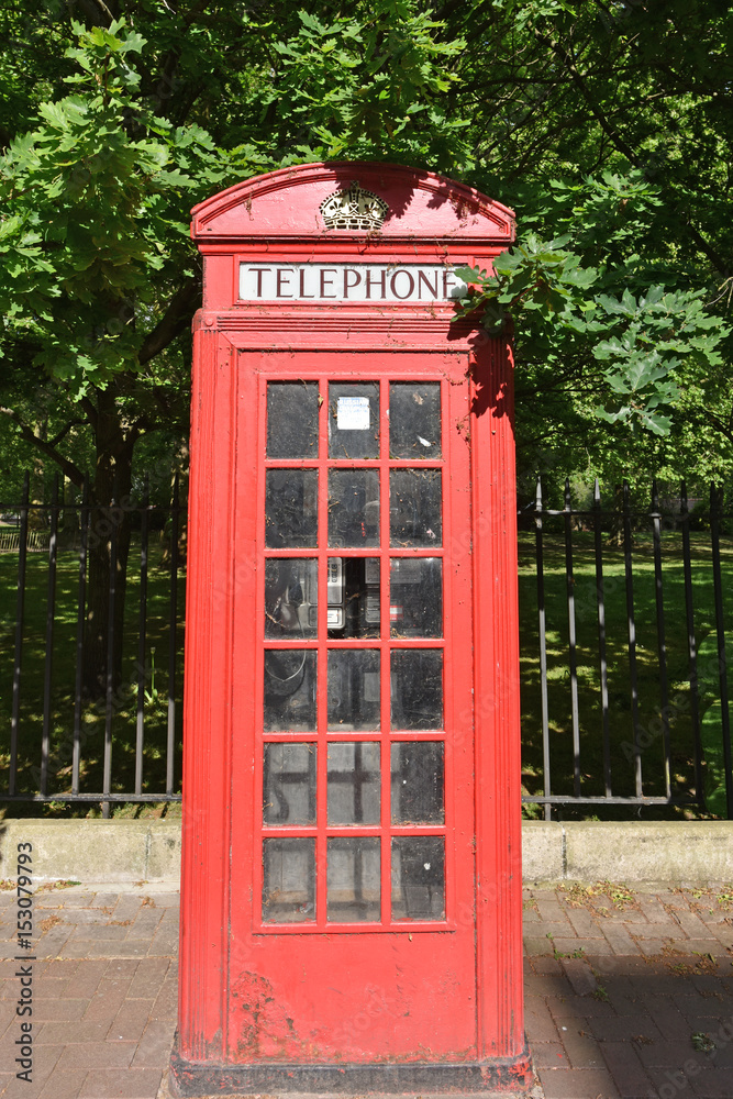 Old Red British Telephone Box on a sidewalk by Battersea Park. Old Red British Telephone Box on a sidewalk by Battersea Park.