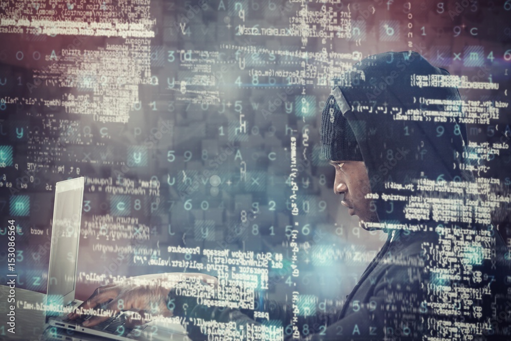 Composite image of male hacker using laptop Composite image of male hacker using laptop