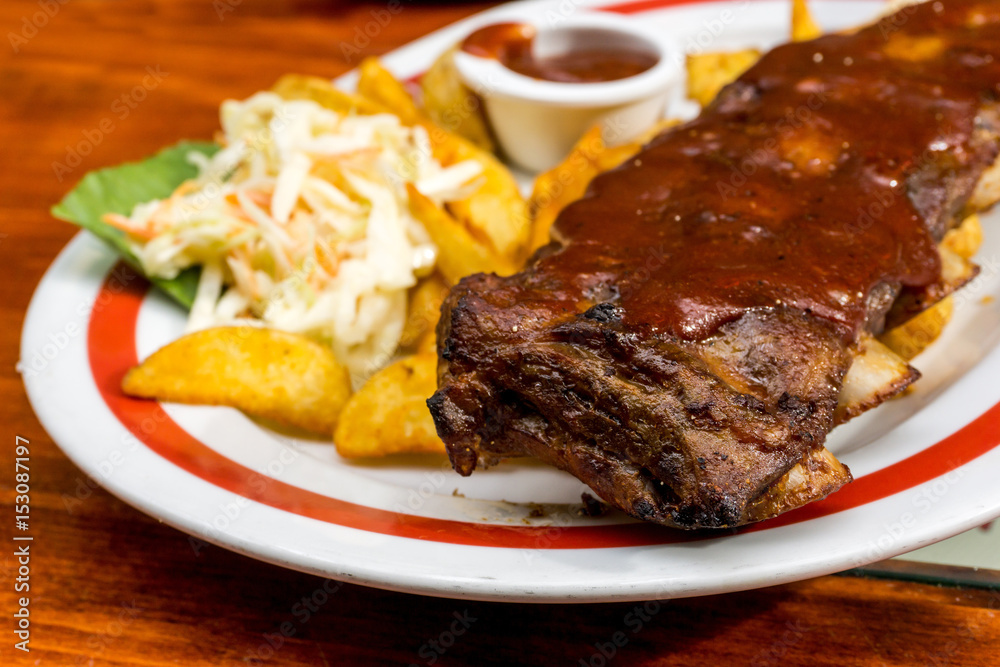 Grilled steak - Grilled meat ribs on the plate with hot sauce