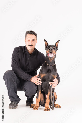 Male dog trainer with dobermann dog photo