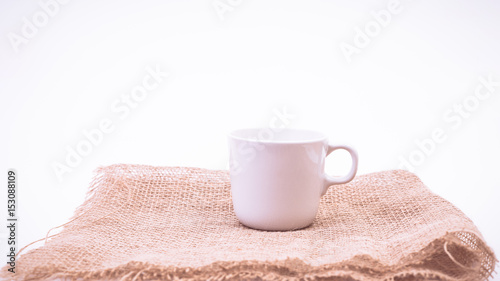 White Coffee mug and sack on white background. vintage color effected