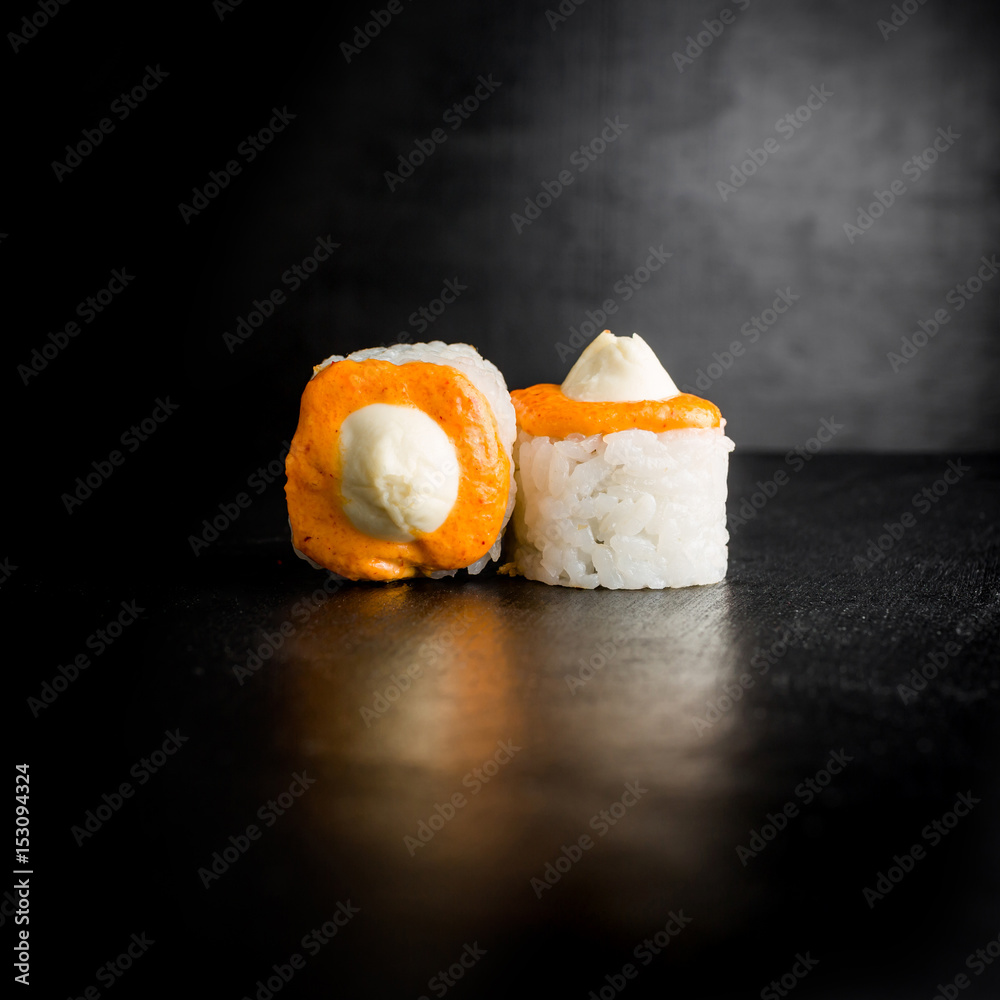 Delicious sushi rolls on dark background. Japanese traditional food. Delicious sushi rolls on dark background. Japanese traditional food.
