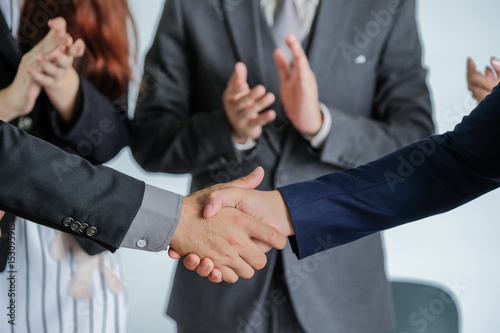 Group of business people meeting shaking hands together, business outdoor meeting concept. photo