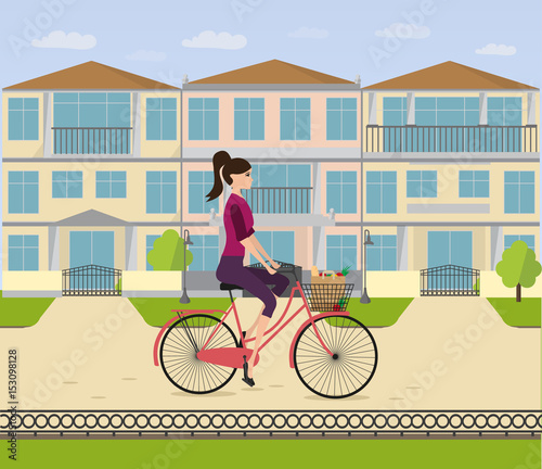 A girl rides a bicycle home in her neighborhood. Woman is cycling from shop with  bag with food