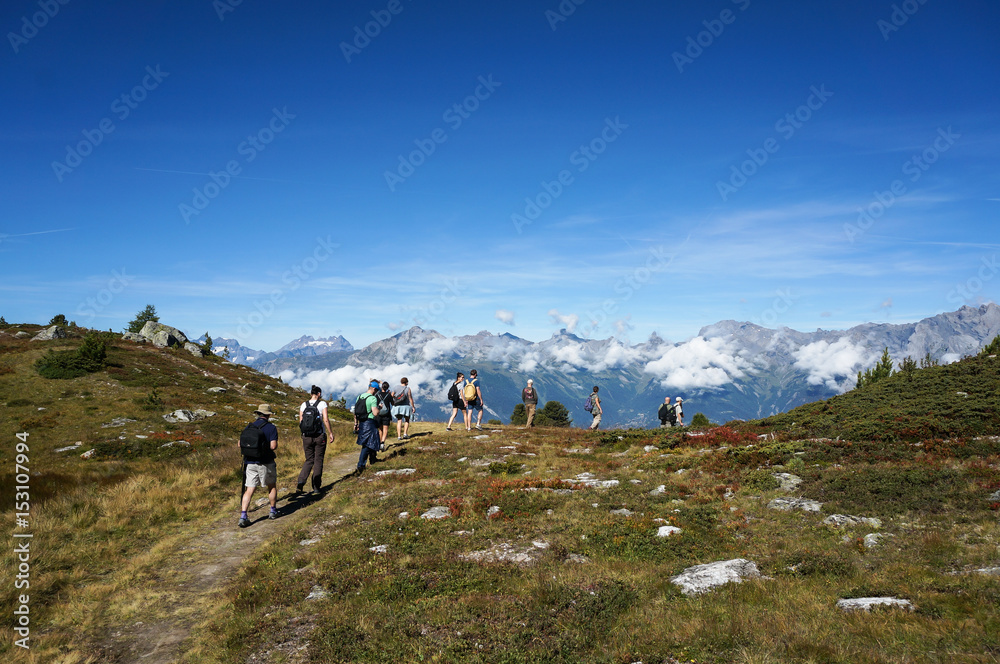 Tourist walking in trekking trial in Nendaz, Switzerland.