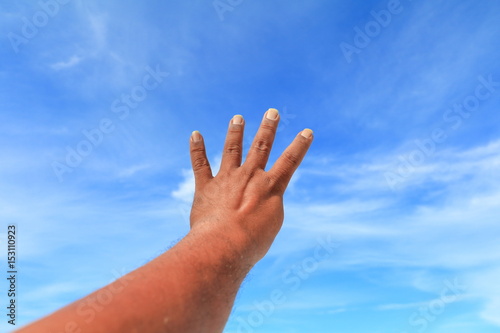 hand show counting number four on sky background