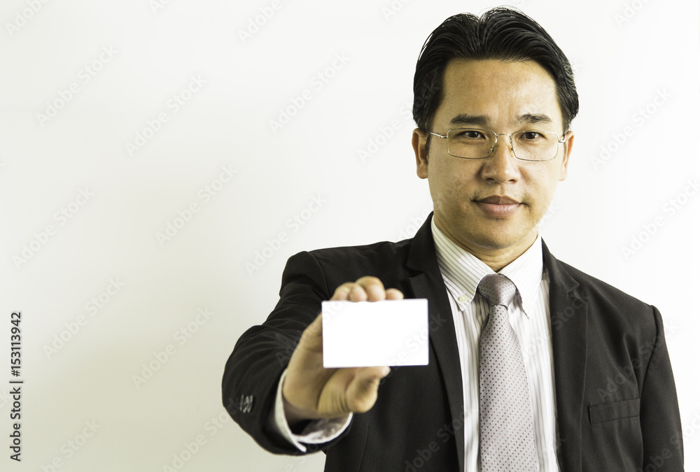 Business man in black suit showing his blank business card ready for your text/photos of young businessman wearing a suit and tie over white background. Business man in black suit showing his blank business card ready for your text/photos of young businessman wearing a suit and tie over white background.