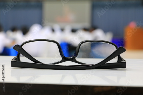 eyeglasses old or spectacles of teacher on the table in seminar conference classroom: Select focus with shallow depth of field.