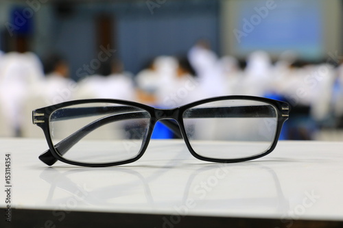 eyeglasses old or spectacles of teacher on the table in seminar conference classroom: Select focus with shallow depth of field.