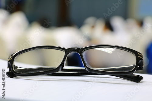 eyeglasses old or spectacles of teacher on the table in seminar conference classroom: Select focus with shallow depth of field.