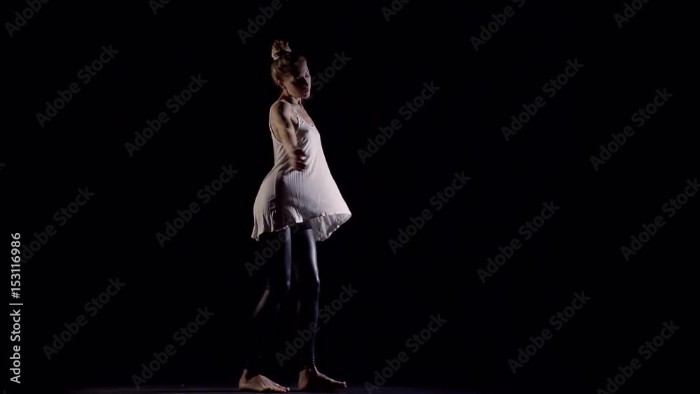 Sexy young girl spinning in a religious dance in the dark Studio Sexy young girl spinning in a religious dance in the dark Studio