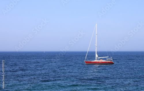 Lonely yacht in sea in summer in southern resort during vacation 