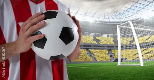 Midsection of player holding soccer ball © vectorfusionart