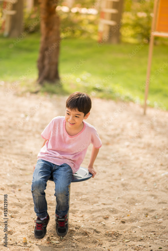 Little boy climbing at playground