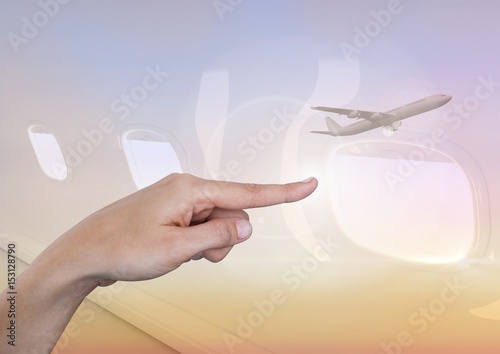 Hand pointing in  air of sky with airplane