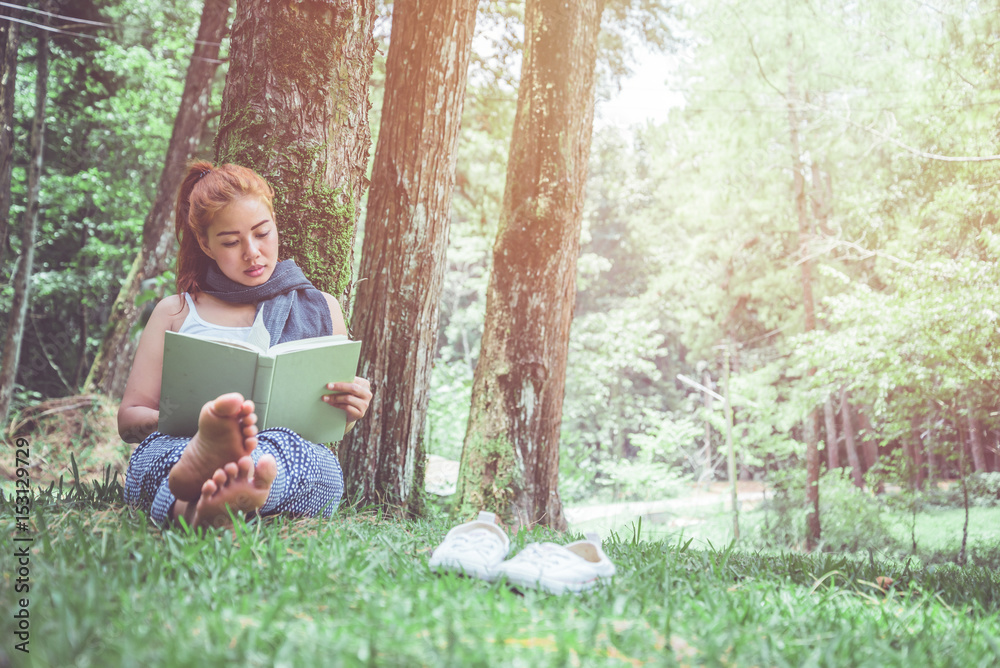 Woman relaxing reading in park. holiday