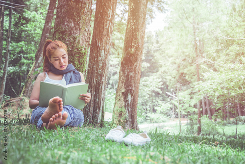 Woman relaxing reading in park. holiday