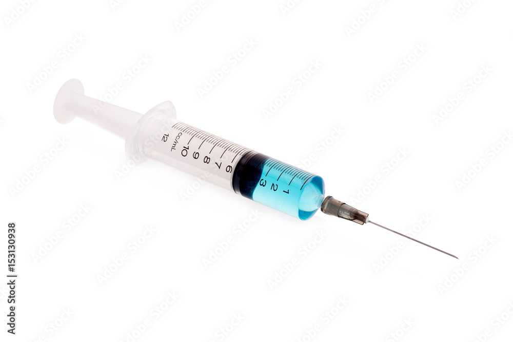 pills and plastic medical syringe on a white background pills and plastic medical syringe on a white background